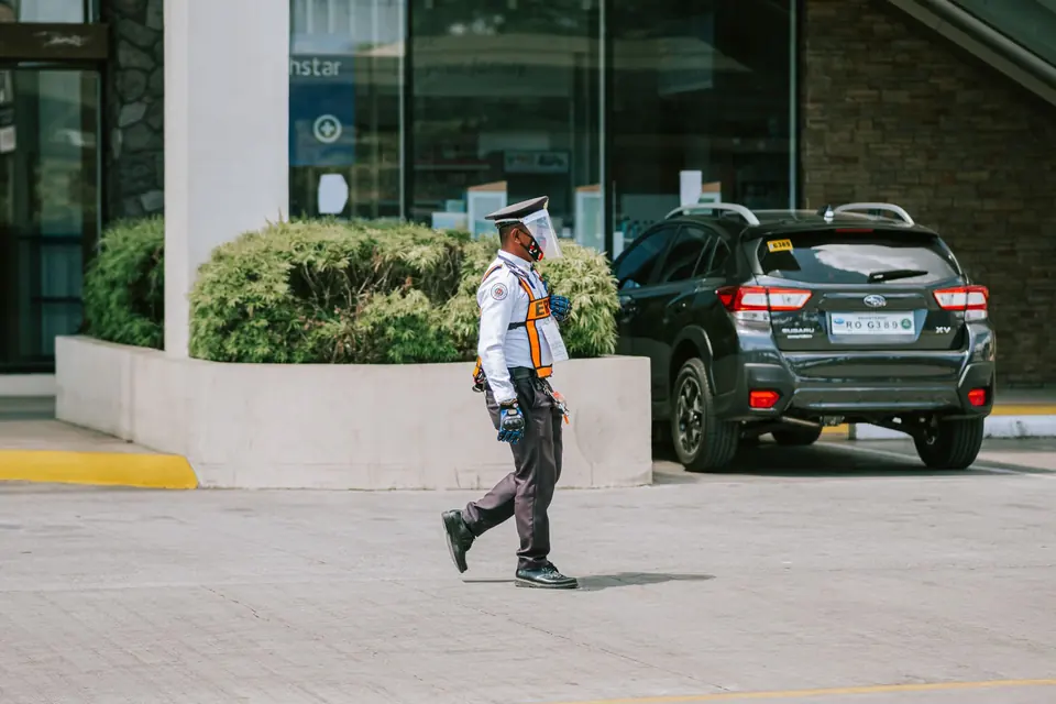 Officer patrolling a parking lot outside a building