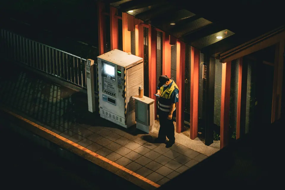 Security officer checking a post at night