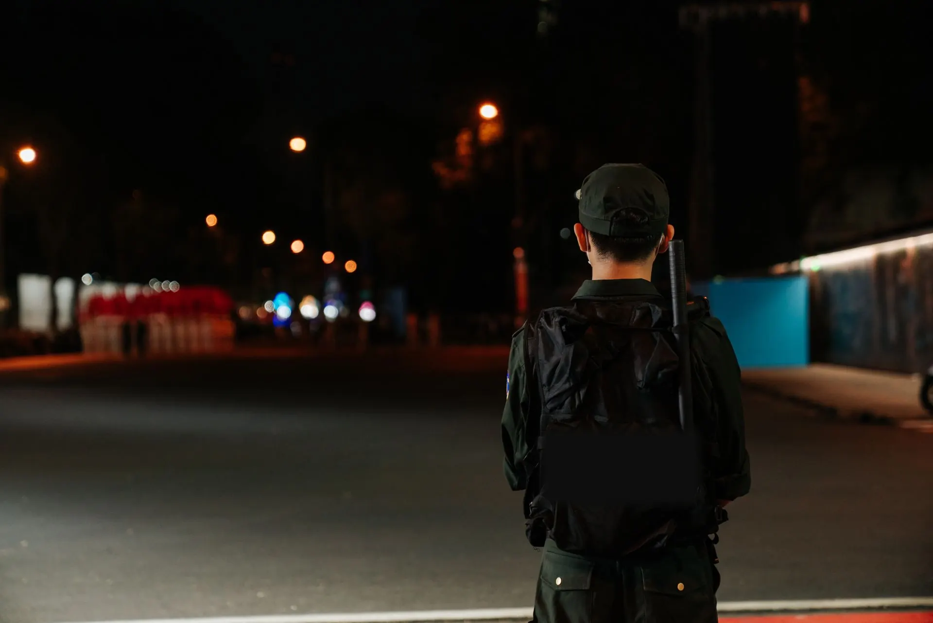 Security officer on night duty watching an empty street