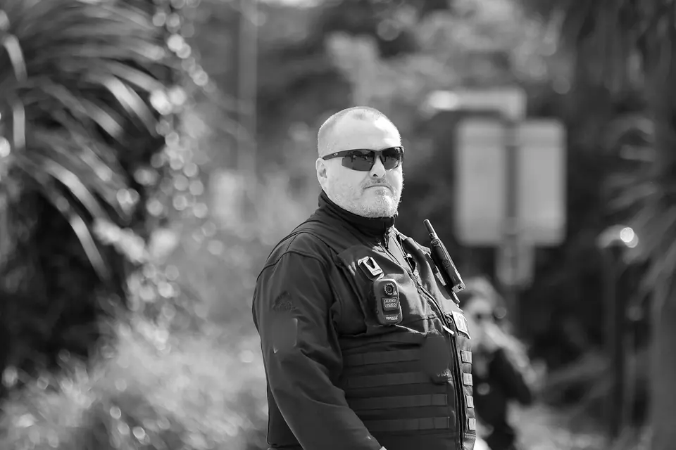 Protection agent in sunglasses watching a crowd